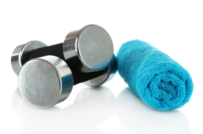Dumbbells with towel isolated on white